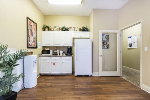 Mini Clubhouse Kitchen with White Cabinets, Fridge and Decorations