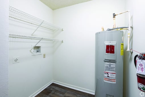 A grey water heater with a red and yellow label on it.