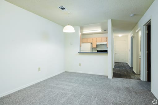 A room with a grey carpet and a white ceiling.