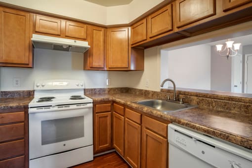 Kitchen with white appliances and wood cabinets