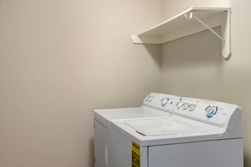 Laundry room with shelf.
