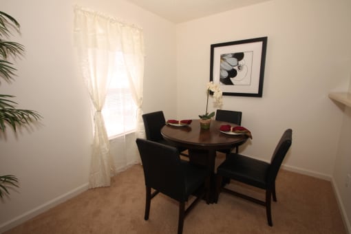 Dining room with carpet flooring, pendant lighting, and wall art