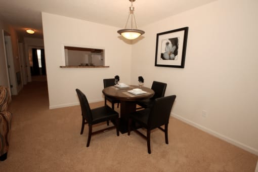 Dining room with carpet flooring and pendant lighting