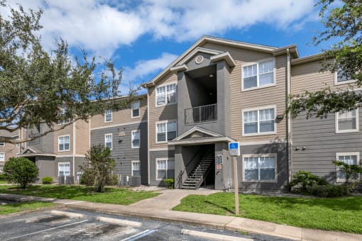 Apartment building exterior surrounded by native landscaping
