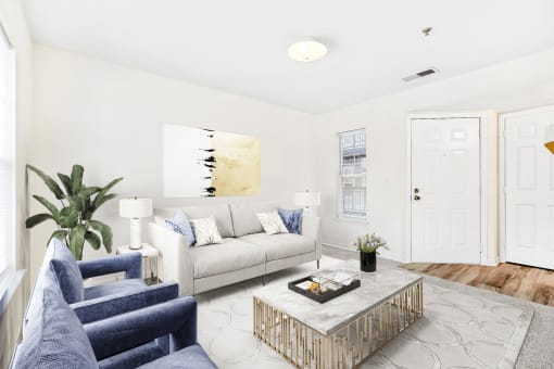 Virtually staged carpeted living room with grey couch and accent chairs with coffee table and modern artwork.