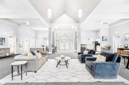Spacious Open Clubhouse Seating Area with Couches Chairs Tables and Coffee bar and a Leasing Desk