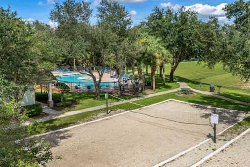 Ariel view of swimming pool and outdoor sand sand volleyball court