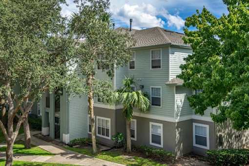 Apartment building exterior surrounded by native landscaping