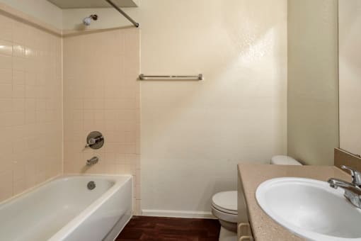 Bathroom with hardwood style flooring and tiled shower