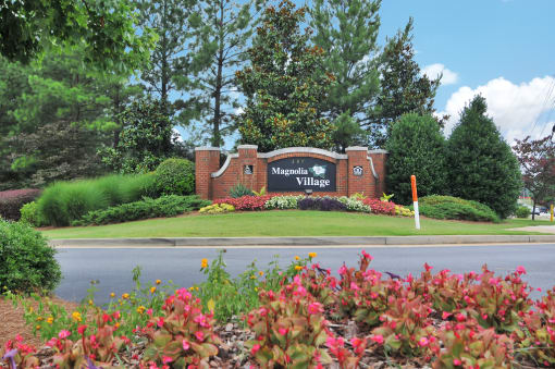 Community sign in the middle of a flower bed.