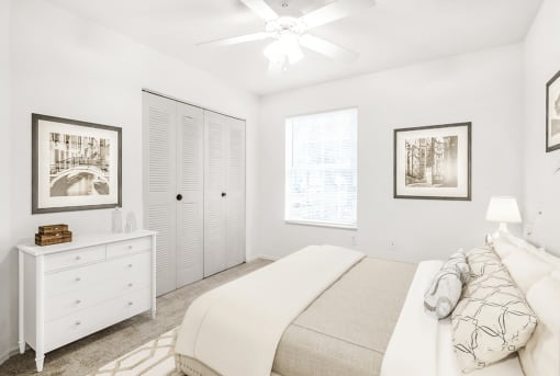Virtually staged bedroom with carpet, accent rug, ceiling fan with light, white dresser, closet, and large window