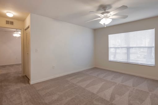 Carpeted Room with Window and Ceiling Fan