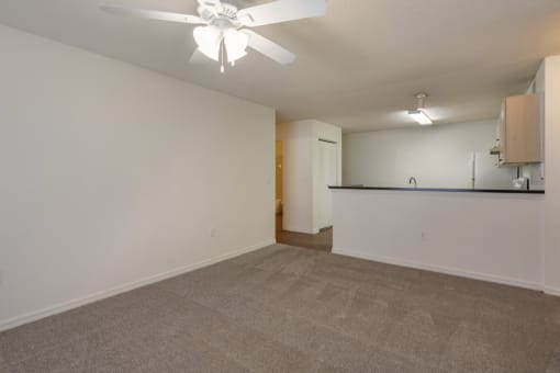 Carpeted Living Room Connected to Breakfast Bar off of Kitchen