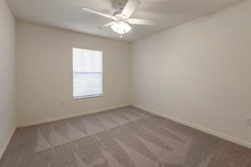 Carpeted Bedroom with Window and Ceiling Fan