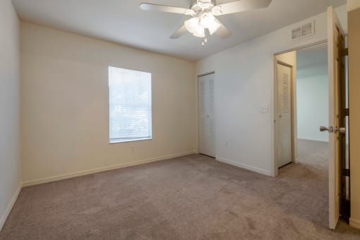 Carpeted Bedroom with Window and Ceiling Fan