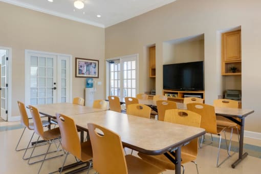 Resident Event and Recreation Room in Clubhouse with tables and chairs, and tv