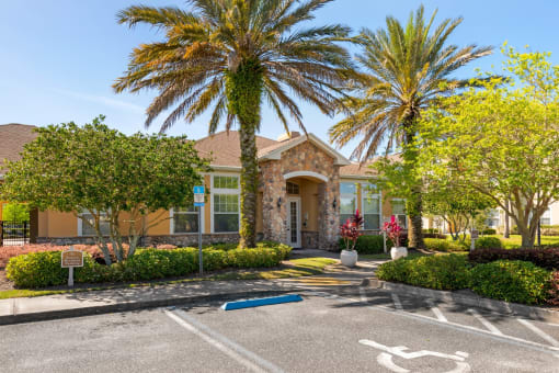 Club House Entrance with long sidewalk surrounded by trees