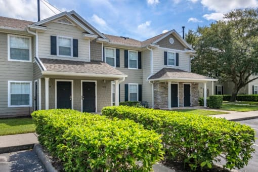 Apartment building exterior surrounded by native landscaping