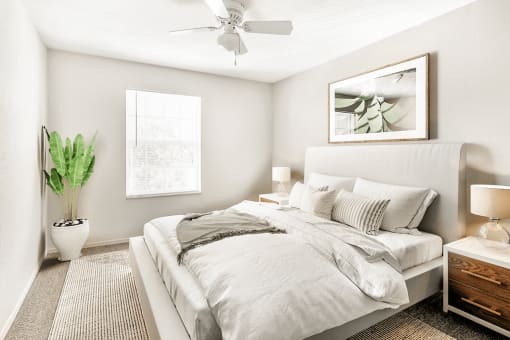 Virtually staged bedroom with carpet, accent rug, ceiling fan with light