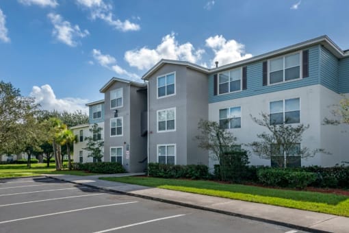 Apartment building exterior surrounded by native landscaping