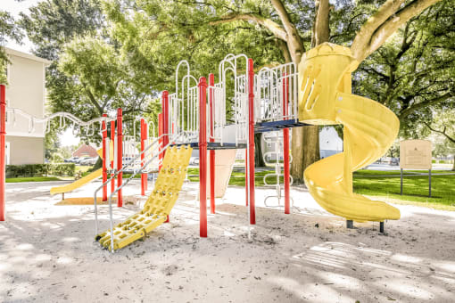 Playground with multiple slides, monkey bars and surrounding native landscape