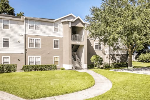 Building exterior with side walk and surrounding native landscape