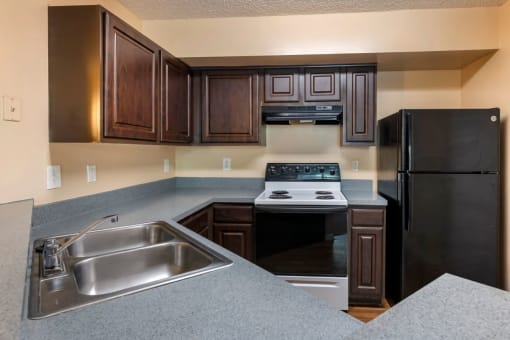 Kitchen breakfast bar, double basin sink, and dark espresso cabinetry
