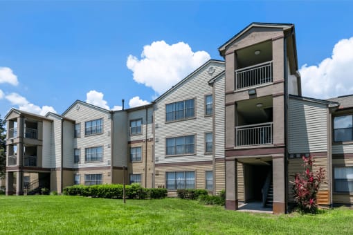 Apartment building exterior surrounded by native landscaping