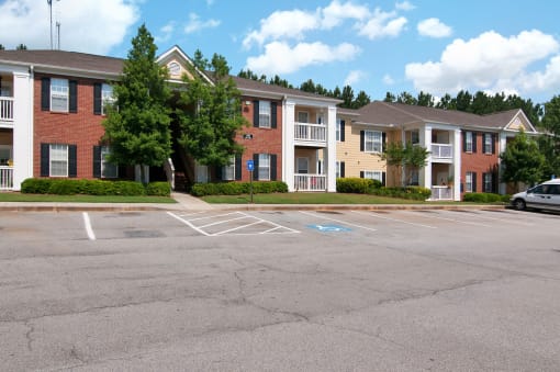 Exterior of apartment with a grass area and bushes by the building