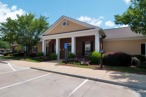 Exterior of leasing office with flower beds