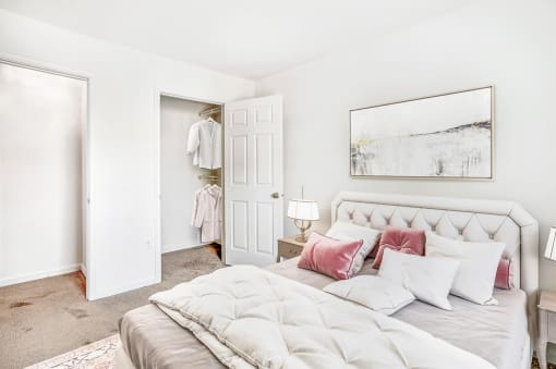 a bedroom with white walls and carpet