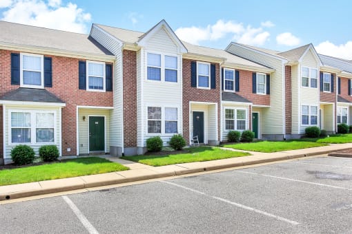 a row of townhomes with a parking lot in front of them