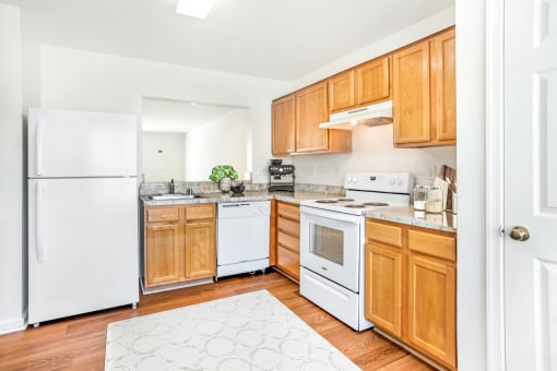 a kitchen with wooden cabinets and white appliances
