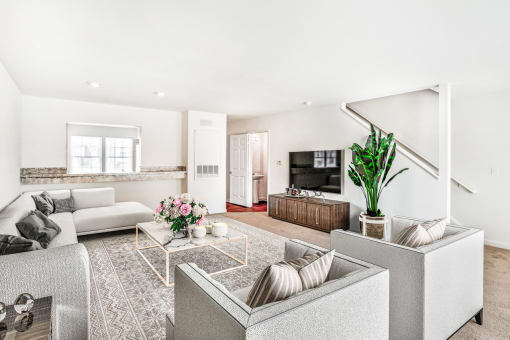 a living room filled with furniture and a large window