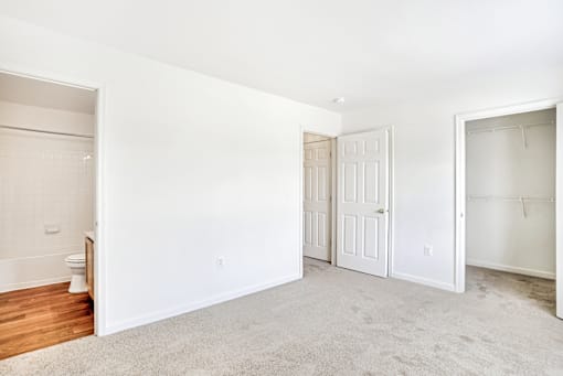 A white room with a toilet and a door.
