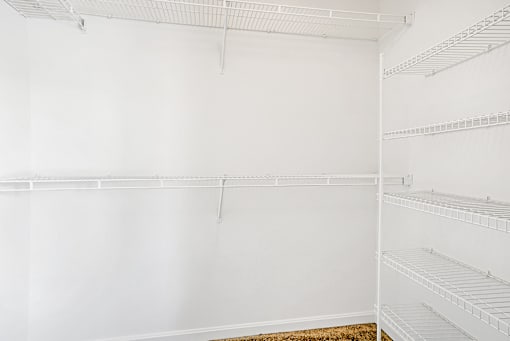 Empty white shelves in a room.