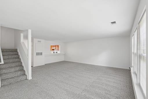 A room with a staircase and a window.