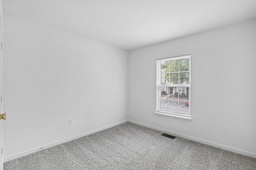 A room with a window and a door.