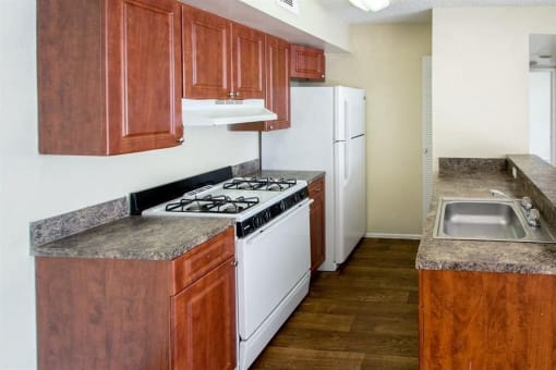 Kitchen with gas stove and white appliances