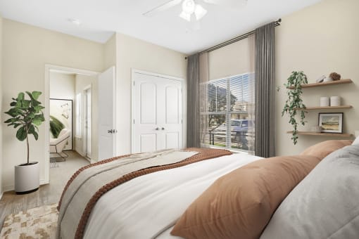 a bedroom with a large bed and a large window
