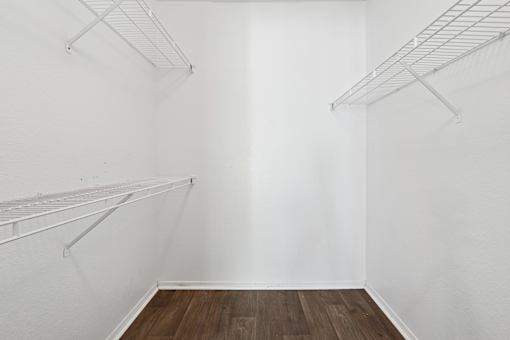 Empty room with white walls and wooden floor.