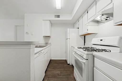 A white kitchen with a stove and oven.