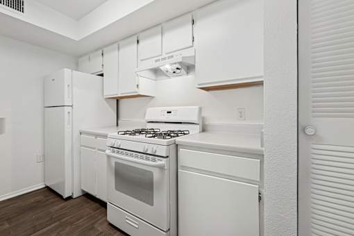 A white kitchen with a stove and oven.