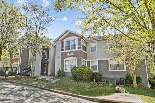 A two-story house with a garage and a driveway.