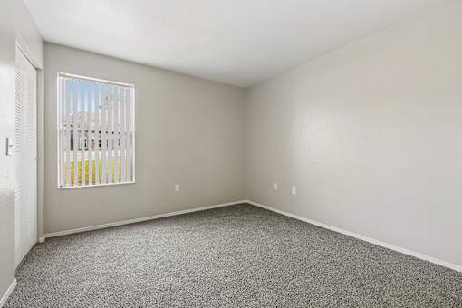 A room with a window and a door.