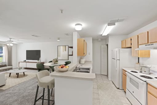 Virtually staged living and kitchen area with white appliances and wood cabinets