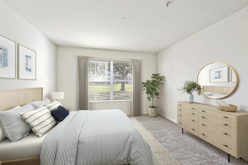 a bedroom with white walls and a large window