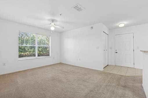 Empty room with carpeted floor and white walls.