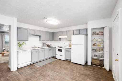 a kitchen with white appliances and a hardwood floor