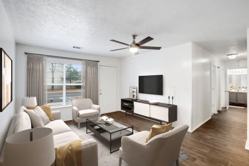 a living room with a ceiling fan and a large window